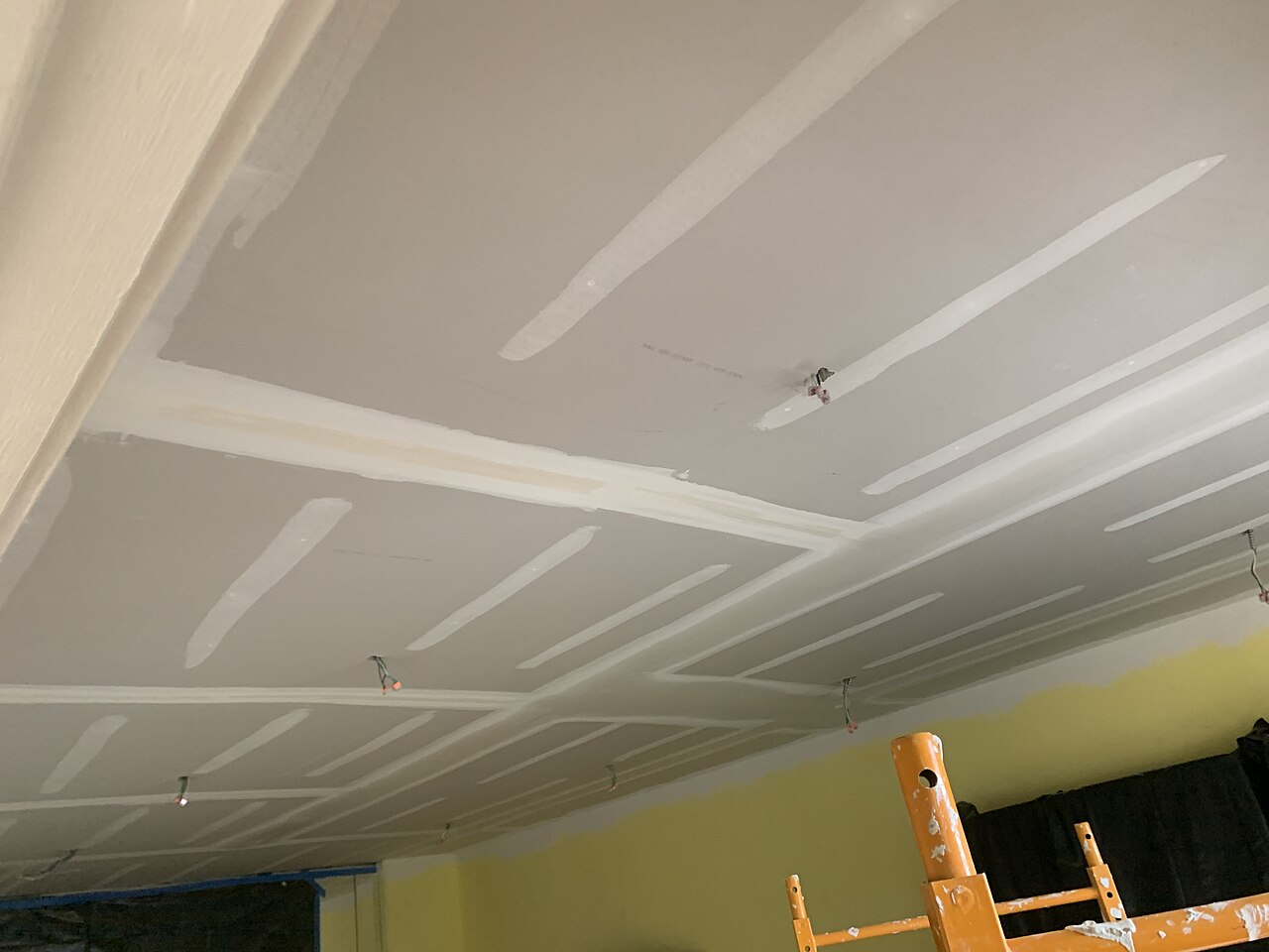 Ceiling under construction with plasterboard and resilient channels for sound insulation