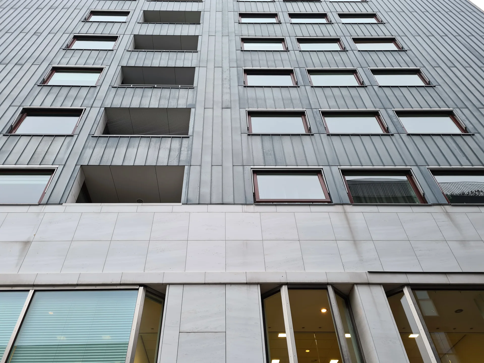 Detail of a facade clad in marble and zinc on the Siza tower in Maastricht