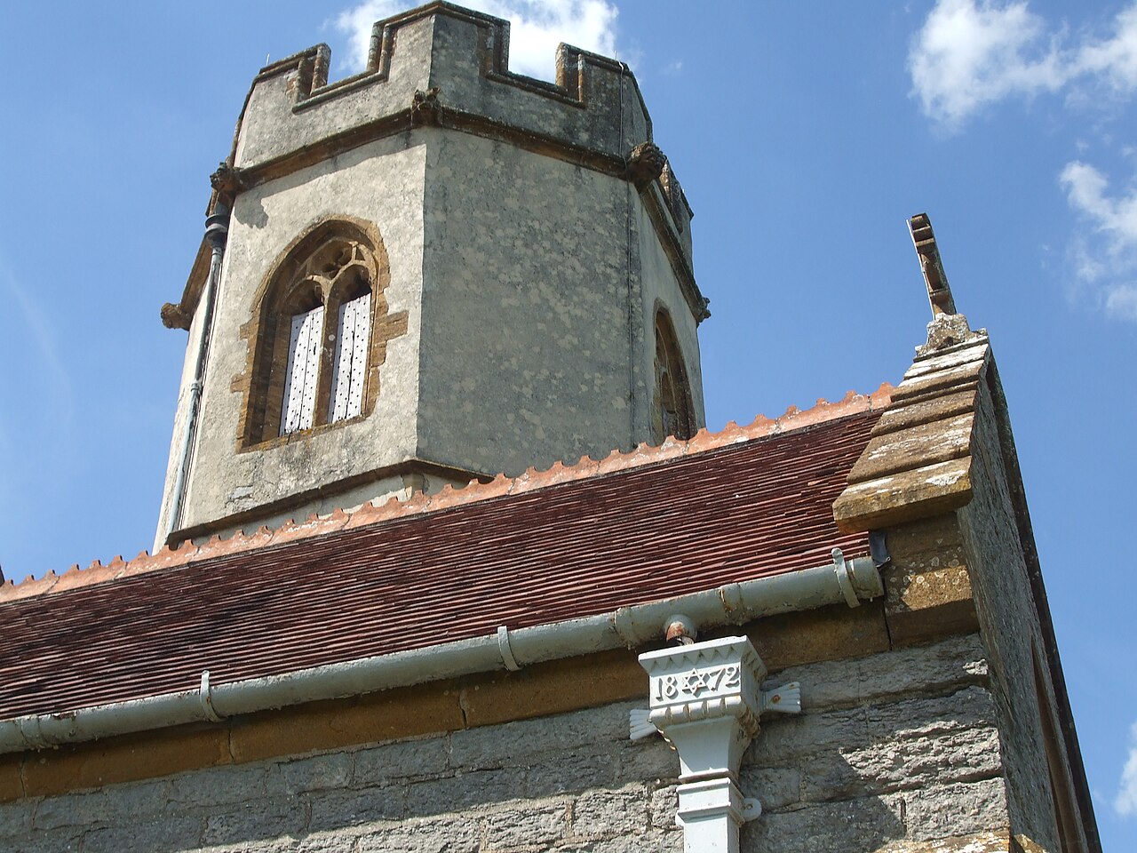 Modern guttering and downpipes fitted to an old church building