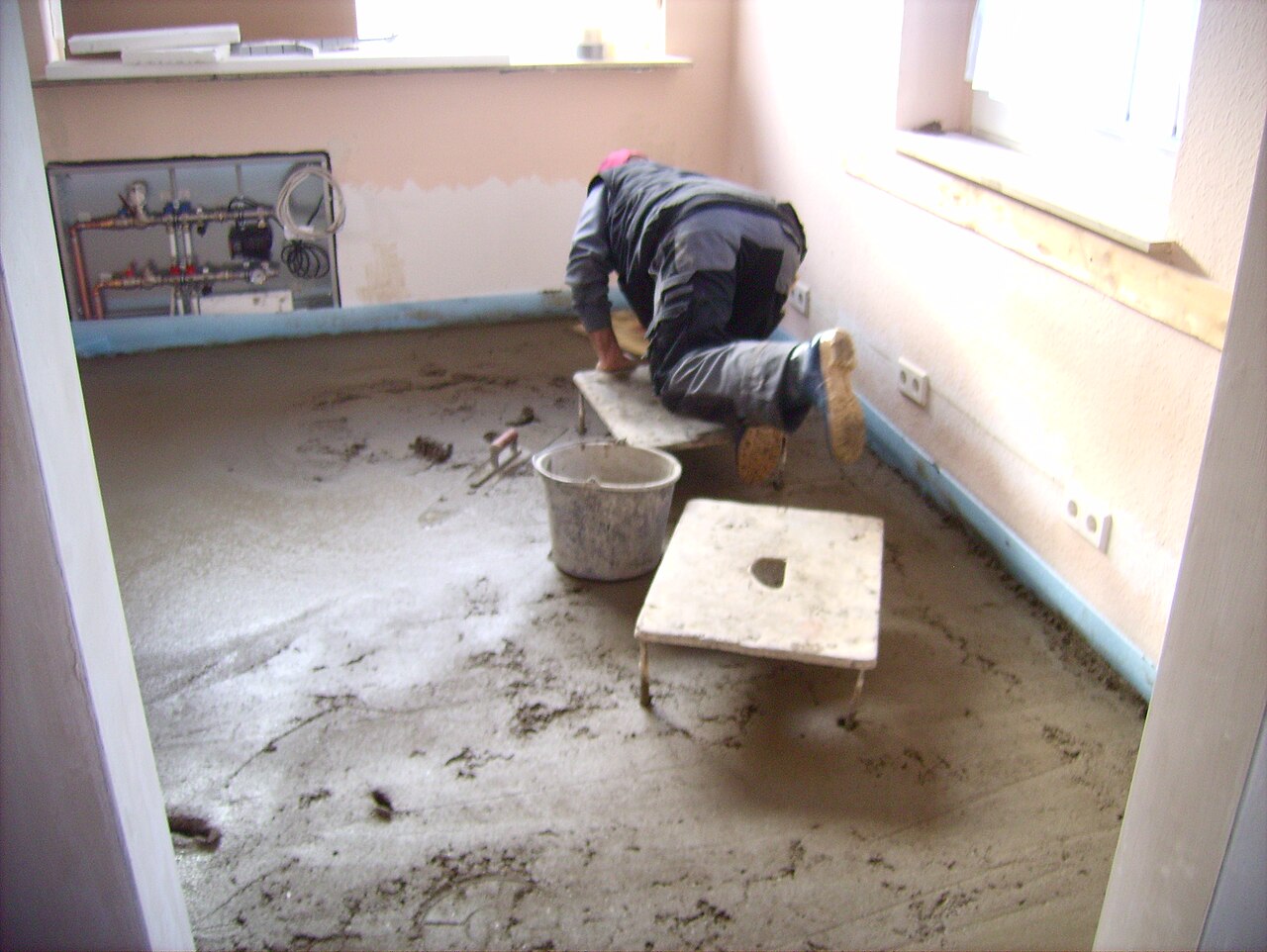 A newly laid screed being smoothed