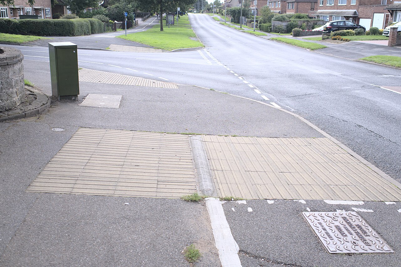 Tactile paving set into a UK footway