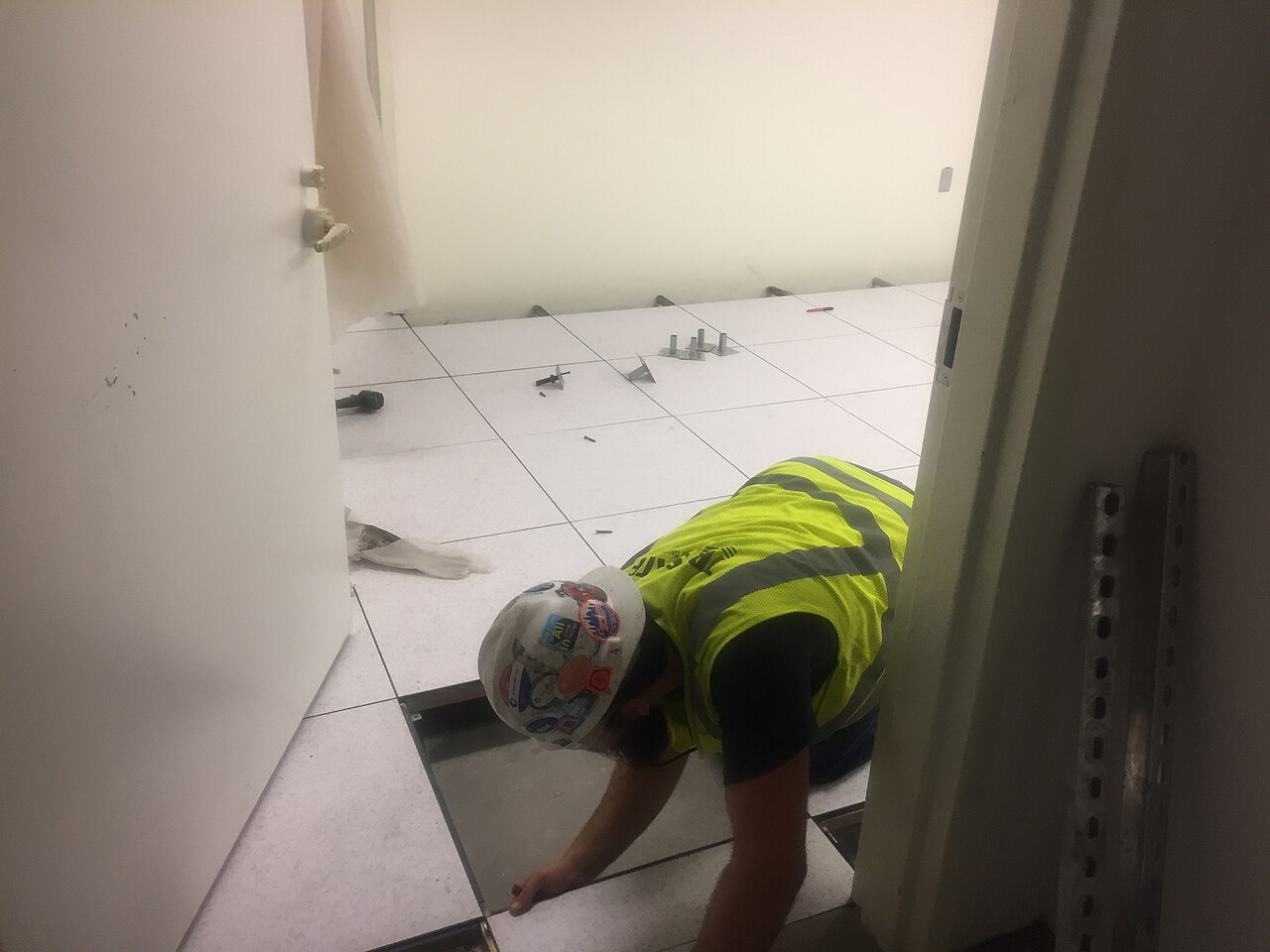 A raised access floor being installed in a back-of-house area