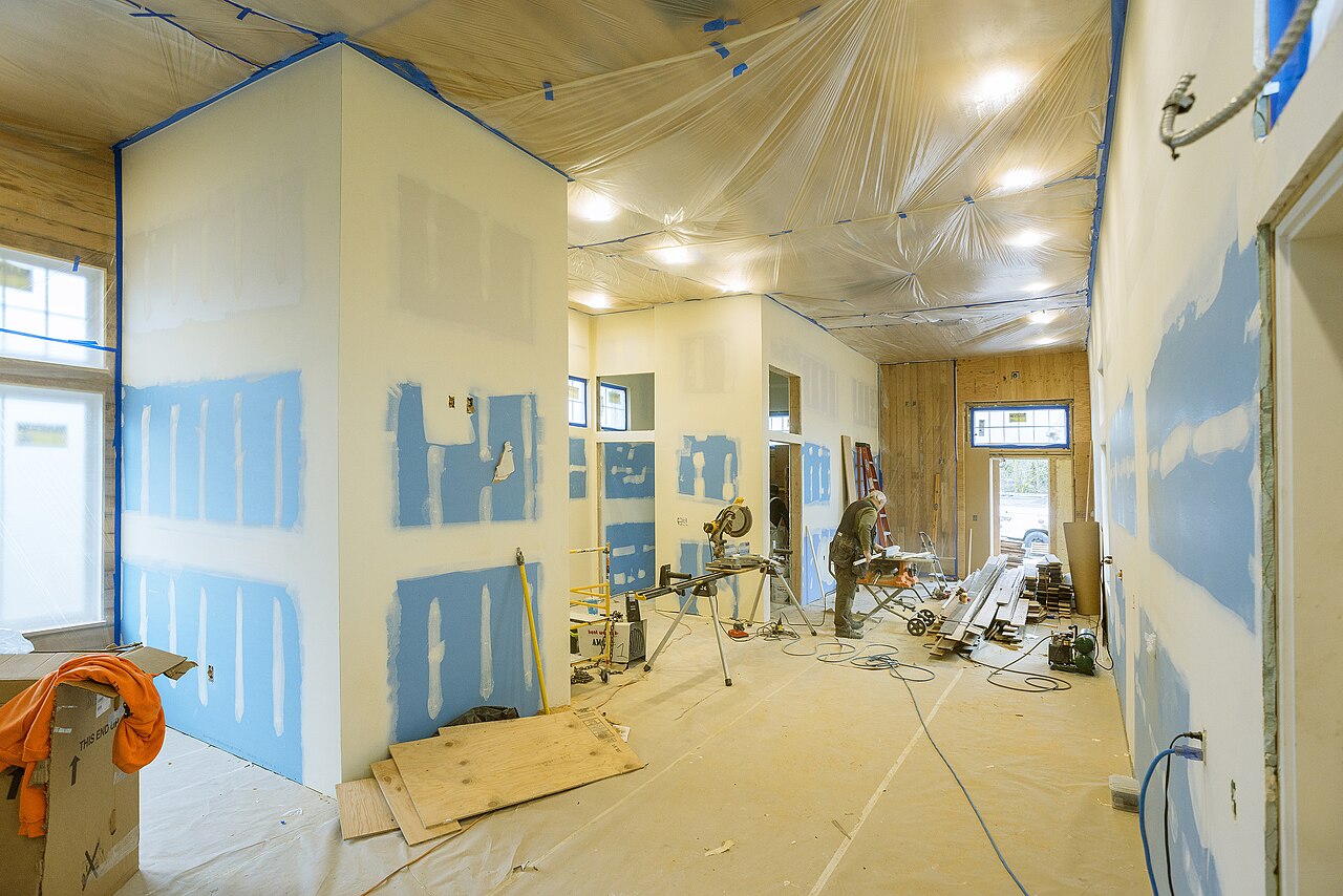 Workers installing drywall boards