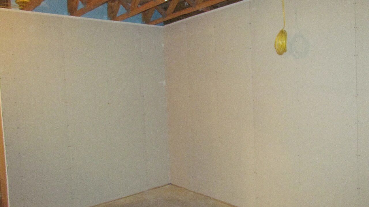 Basement walls with insulation completed and drywall installed over it