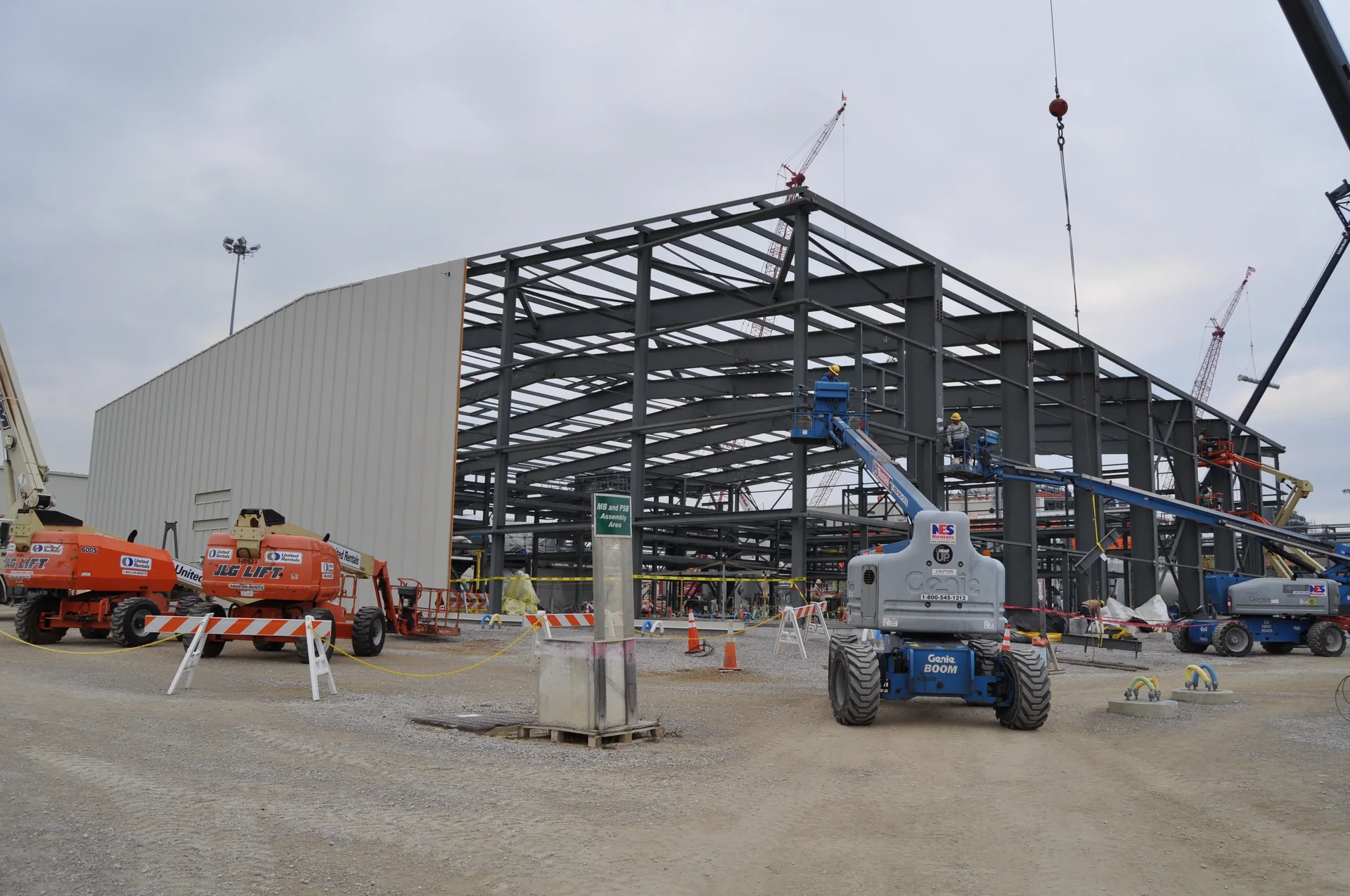 Exterior wall panels being installed on an industrial process building under construction