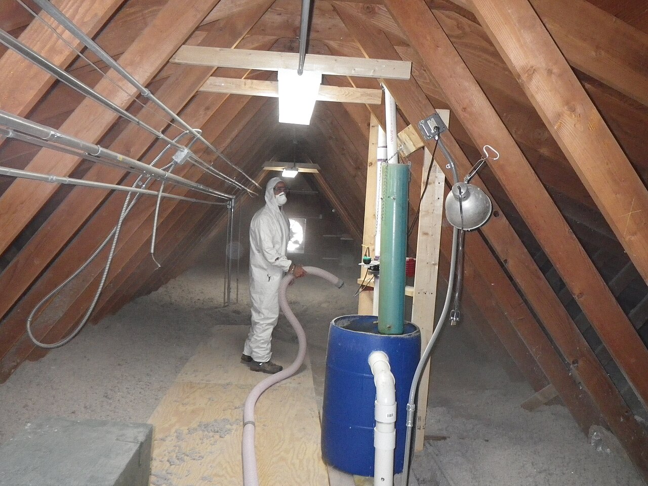 Cellulose insulation being blown into an attic