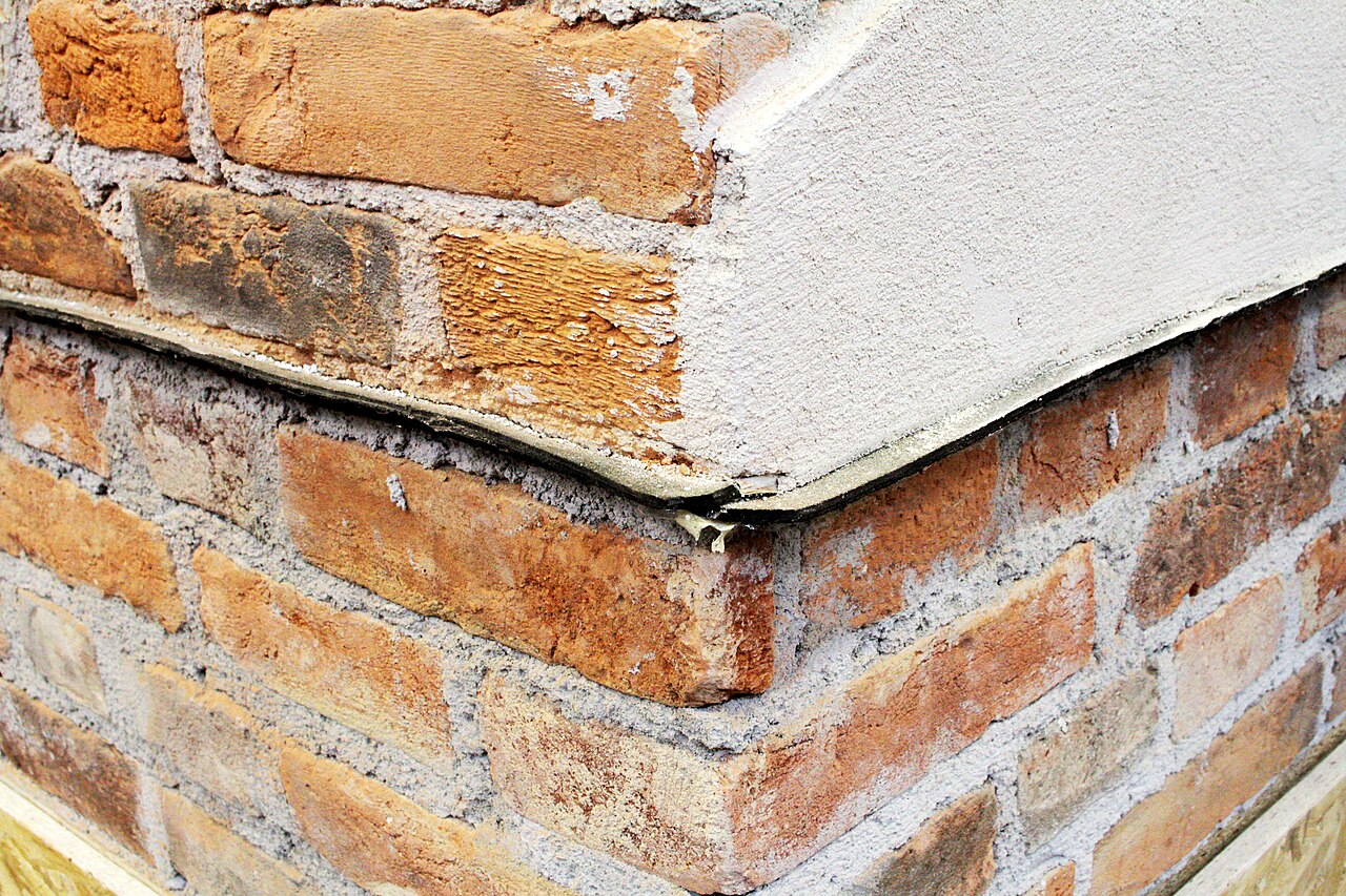A black sheet damp-proof course laid in a brick wall