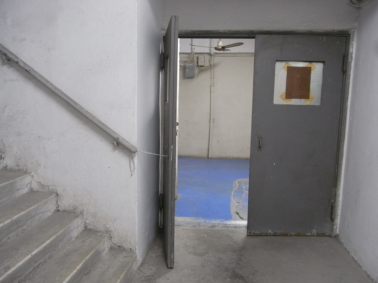 An open smoke stop door on a staircase in a multi-storey building in Hong Kong