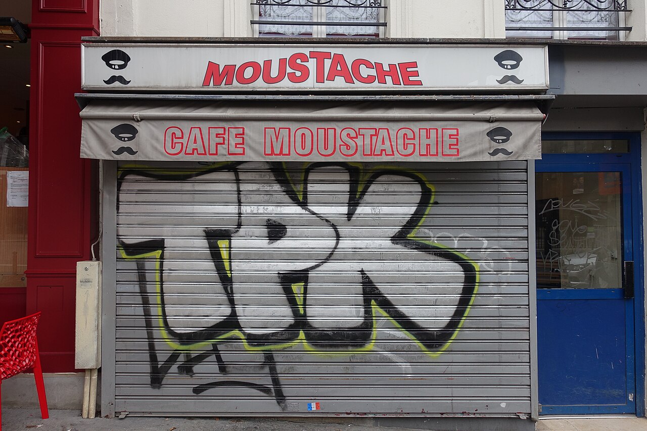 Roller shutters on ground-floor shopfronts on Rue du Faubourg Saint-Martin, Paris