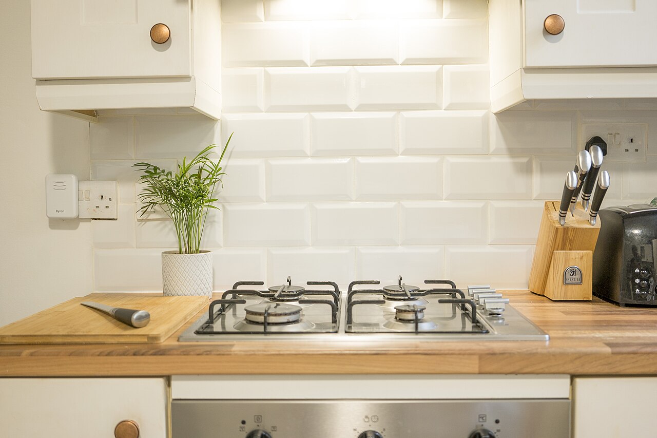 A gas hob fitted into a wooden kitchen worktop