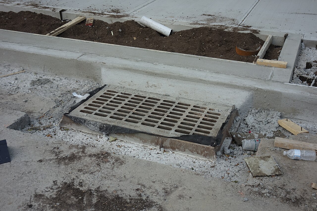 Stormwater infiltration structures under construction at a street corner in Queens, New York