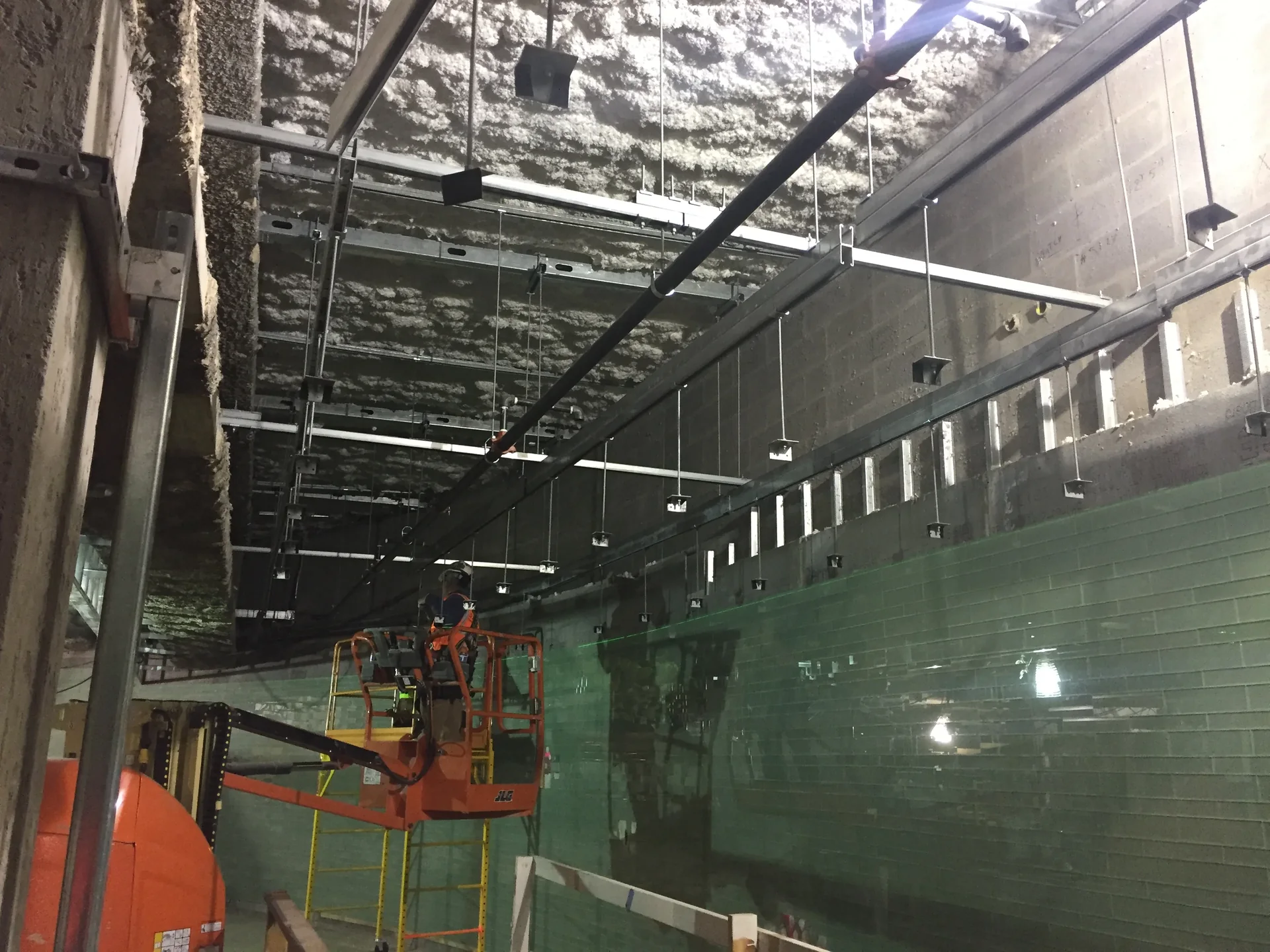 Carpenters installing metal ceiling framing before boarding