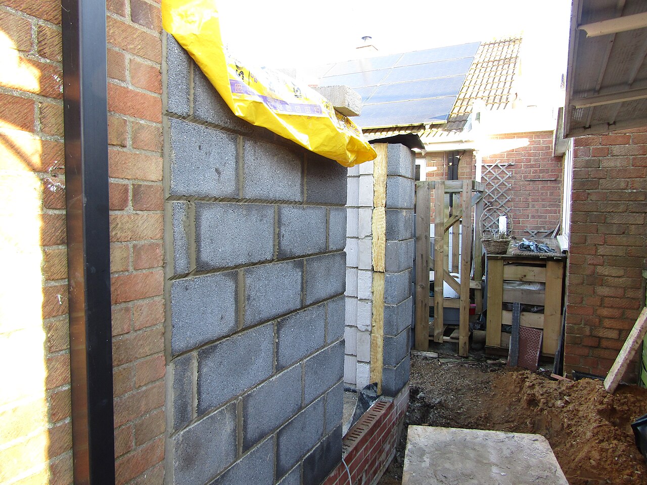 A cavity wall under construction in concrete blocks with an opening left in it, Trimingham, Norfolk