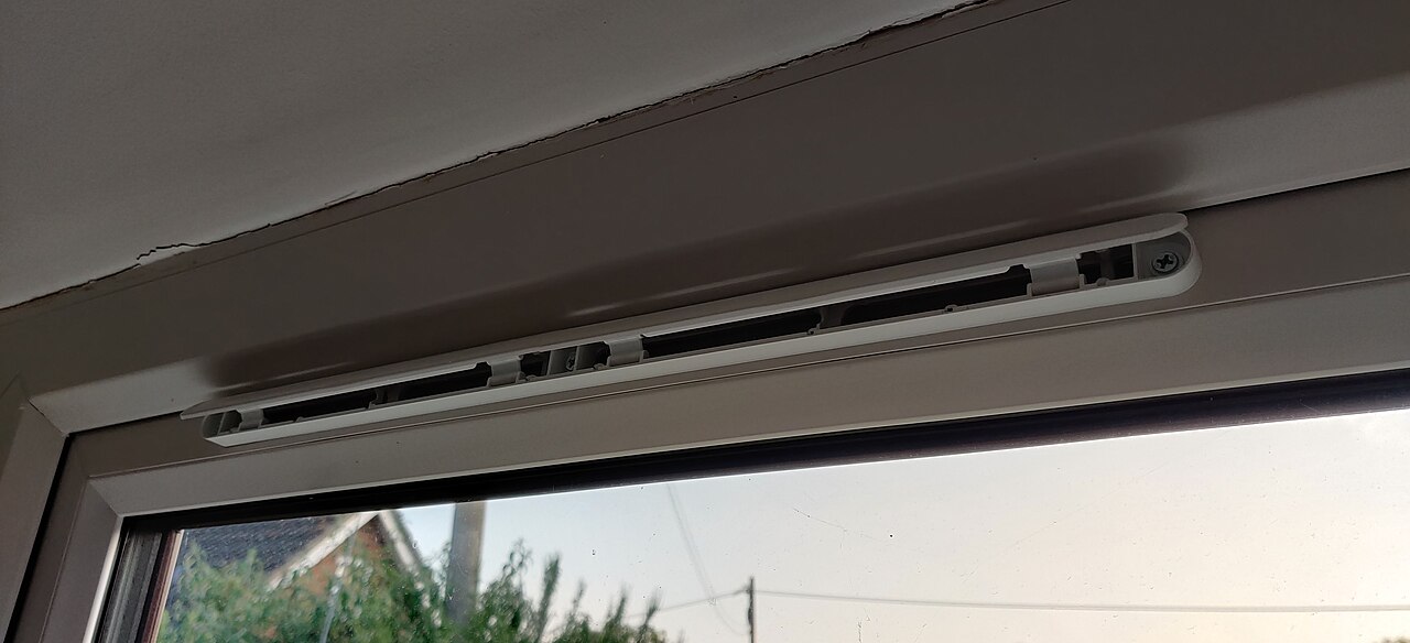 A trickle vent in the open position on a window frame