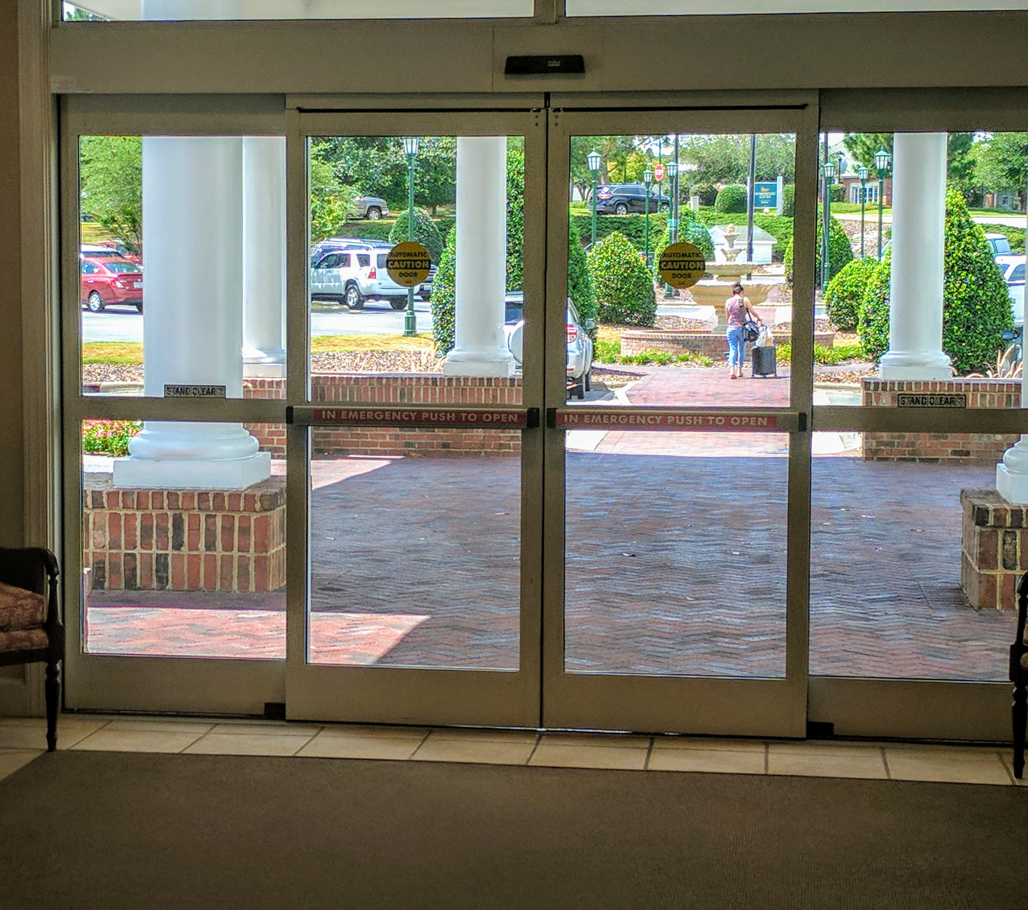 Automatic doors in a hotel fitted with crash bars for emergency exit