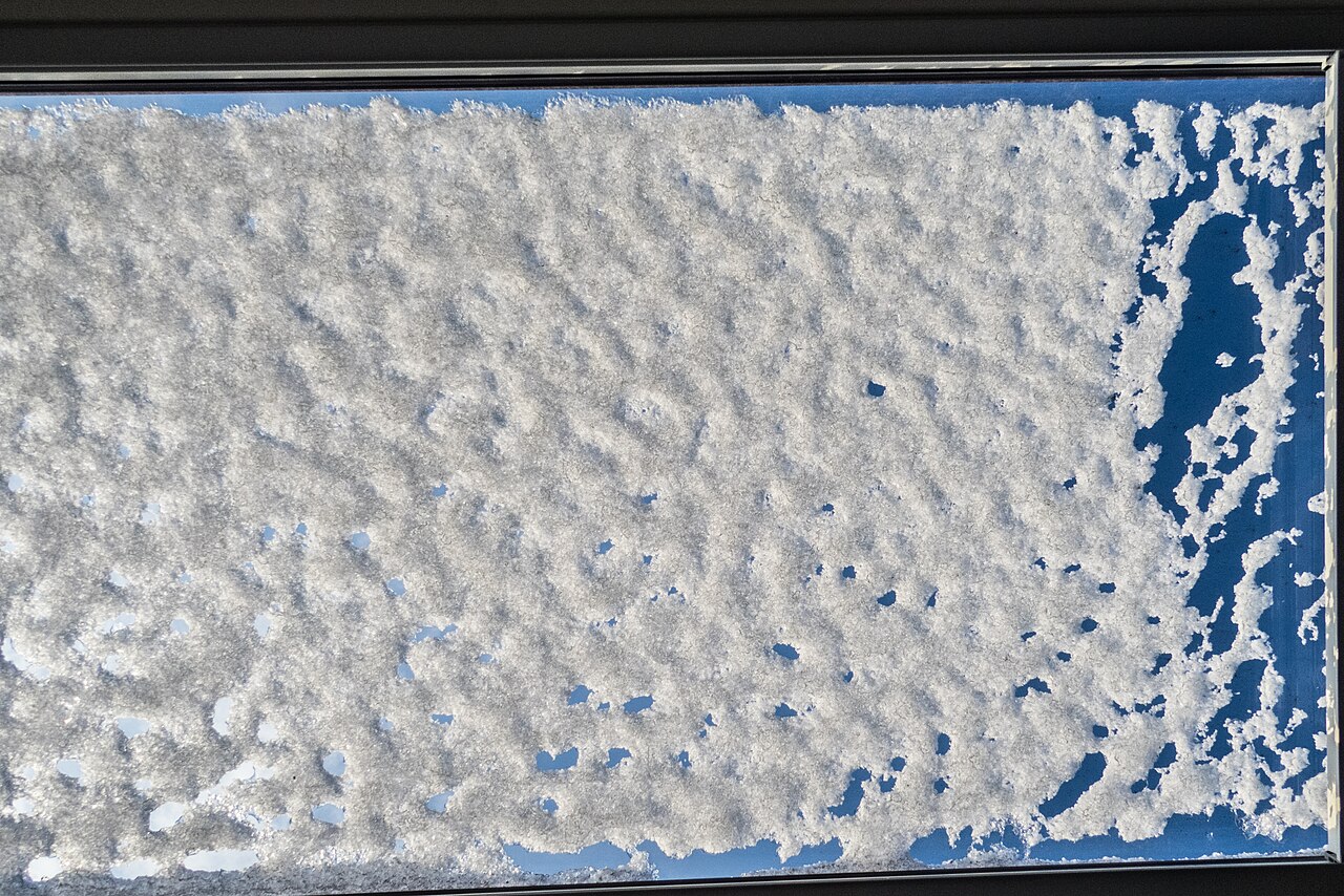 Snow lying on a roof window in a pitched roof