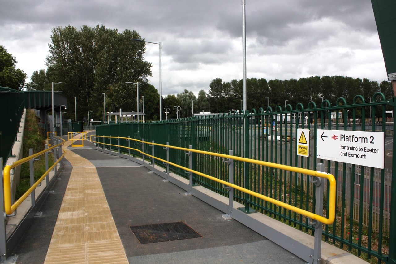 Yellow tactile paving at the entrance to a station platform in Exeter