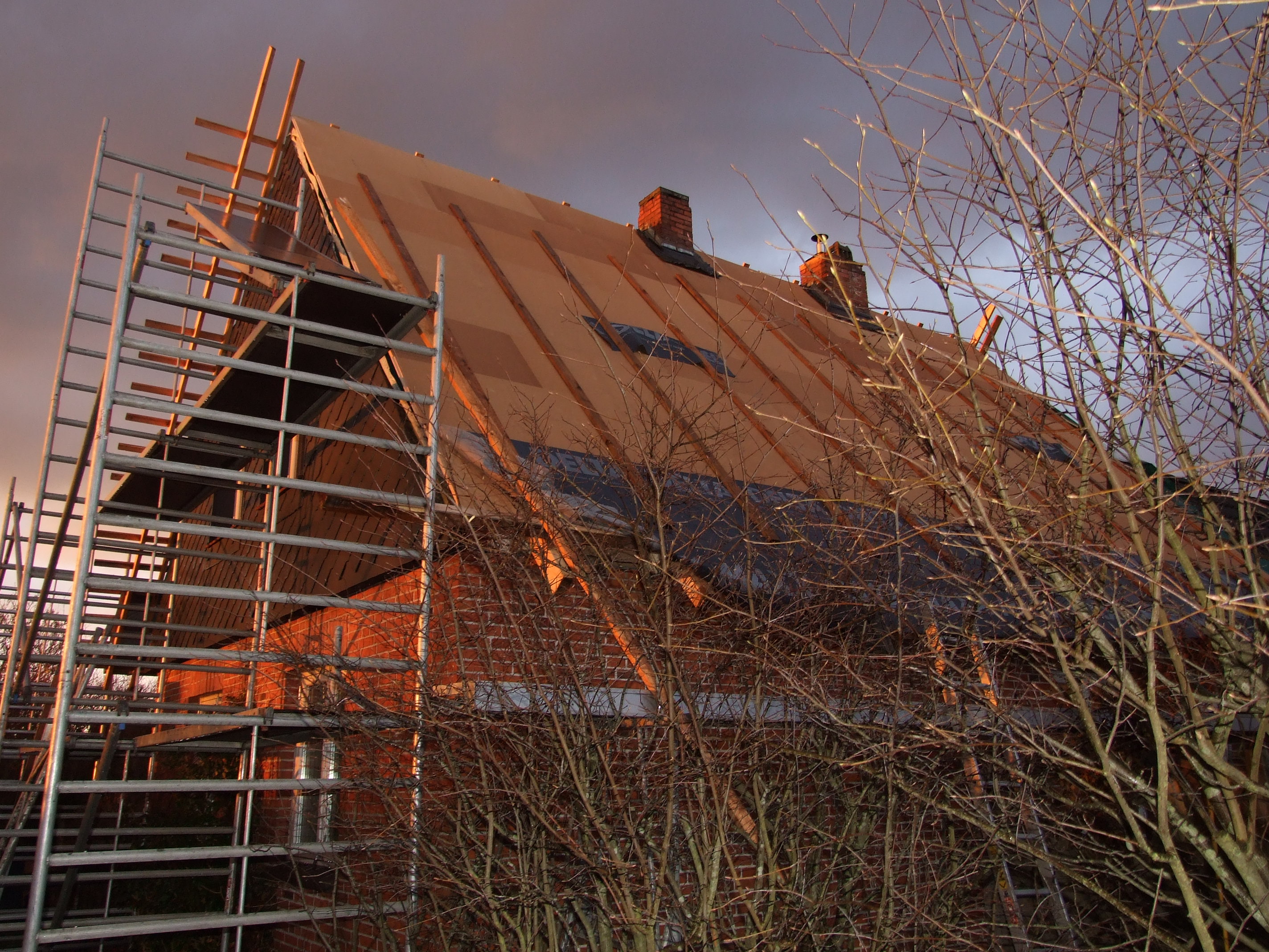 Wood fibre insulation boards laid over the rafters of a house roof