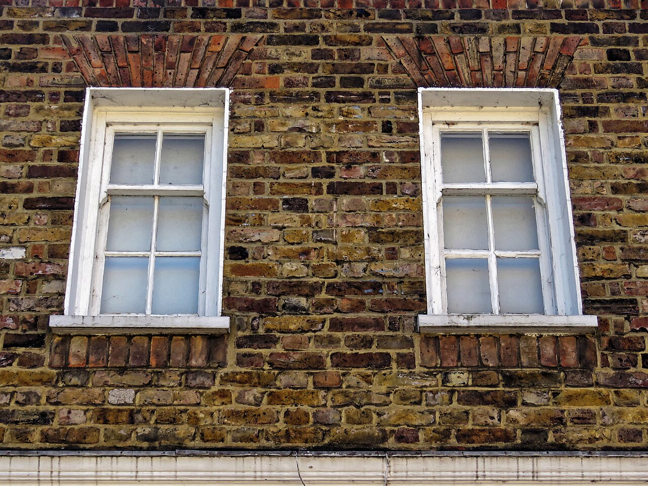 Upper-floor sash windows on a terraced street in Tottenham, London