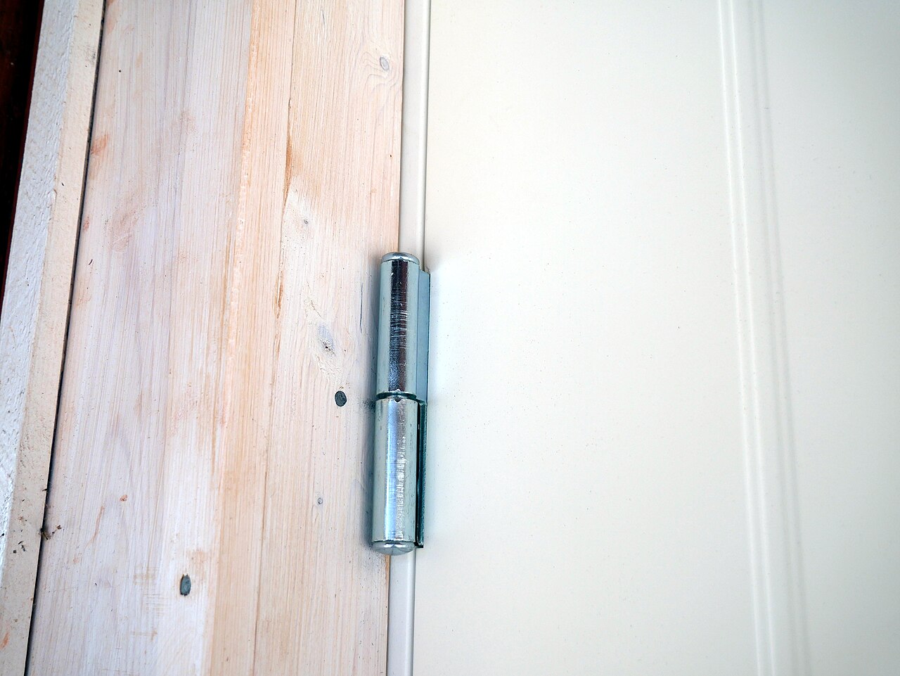 A metal hinge fitted to a door