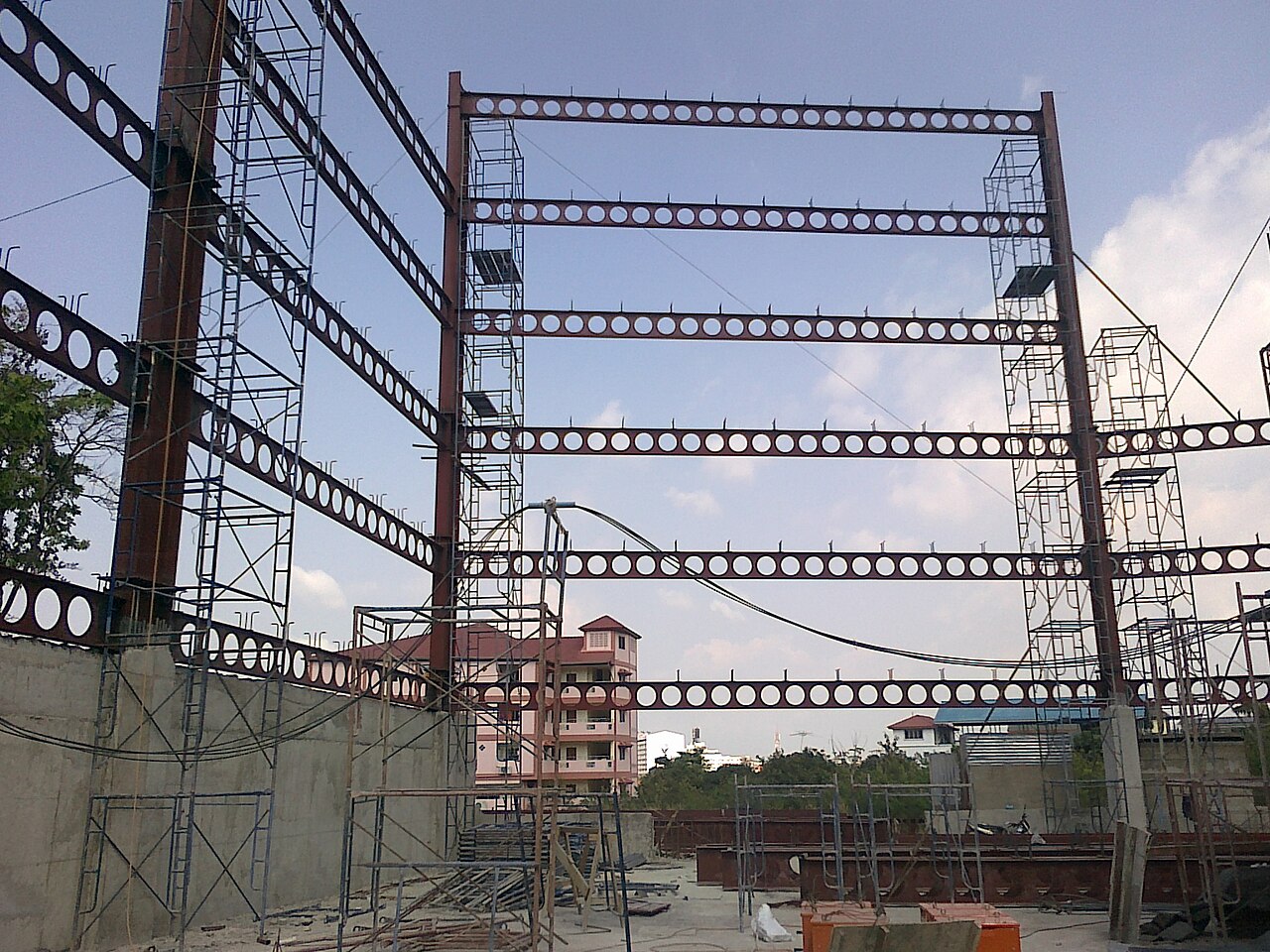 Steel columns and cellular steel beams in the frame of a residential building under construction