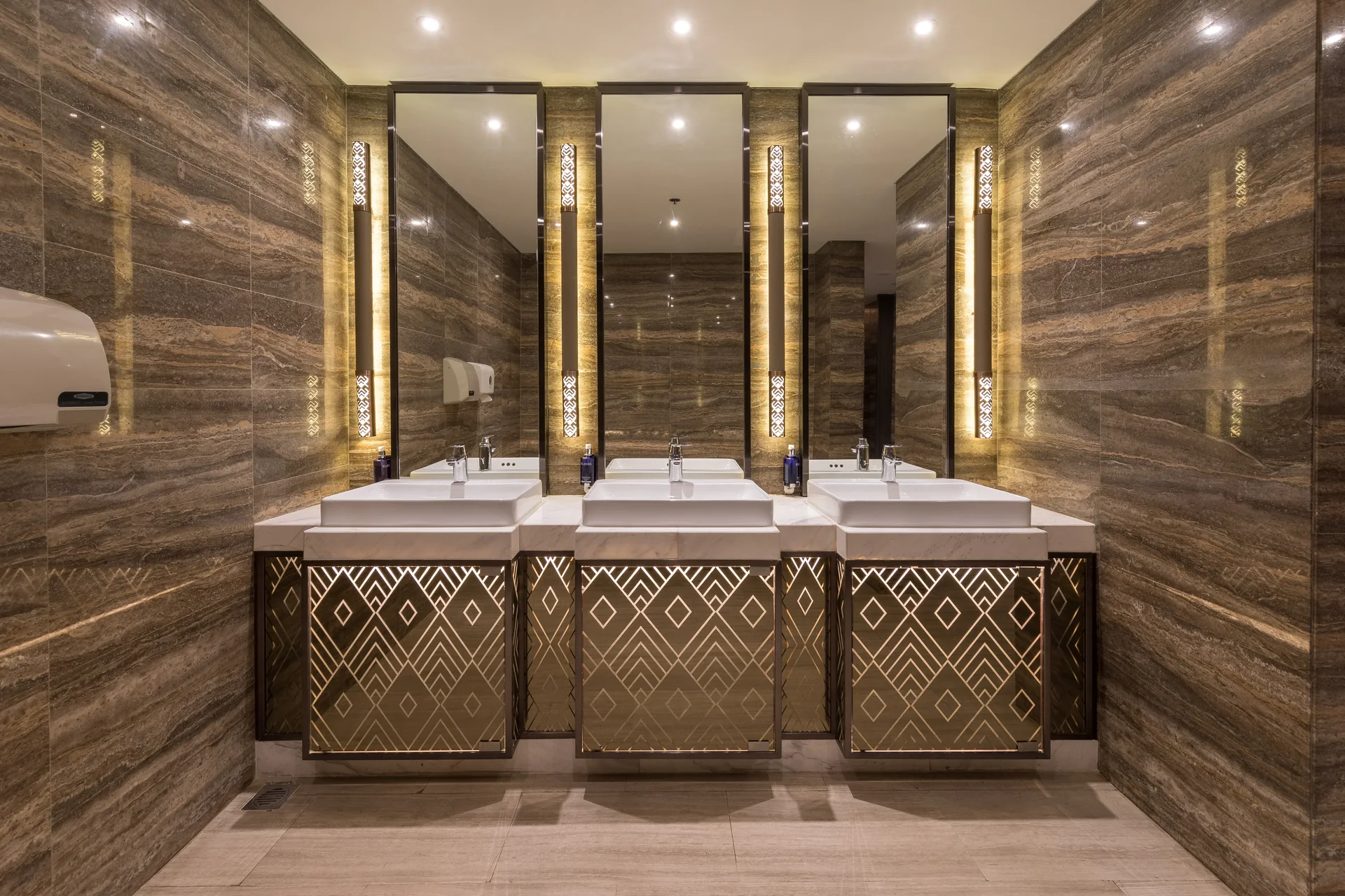 A row of washbasins in the restrooms of a hotel