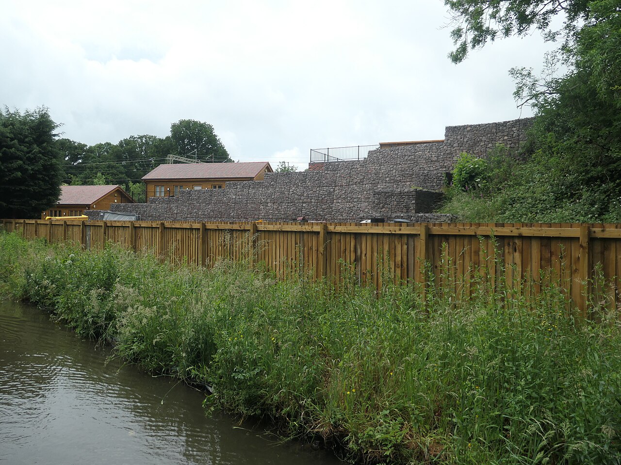 A retaining wall built from stacked gabion baskets