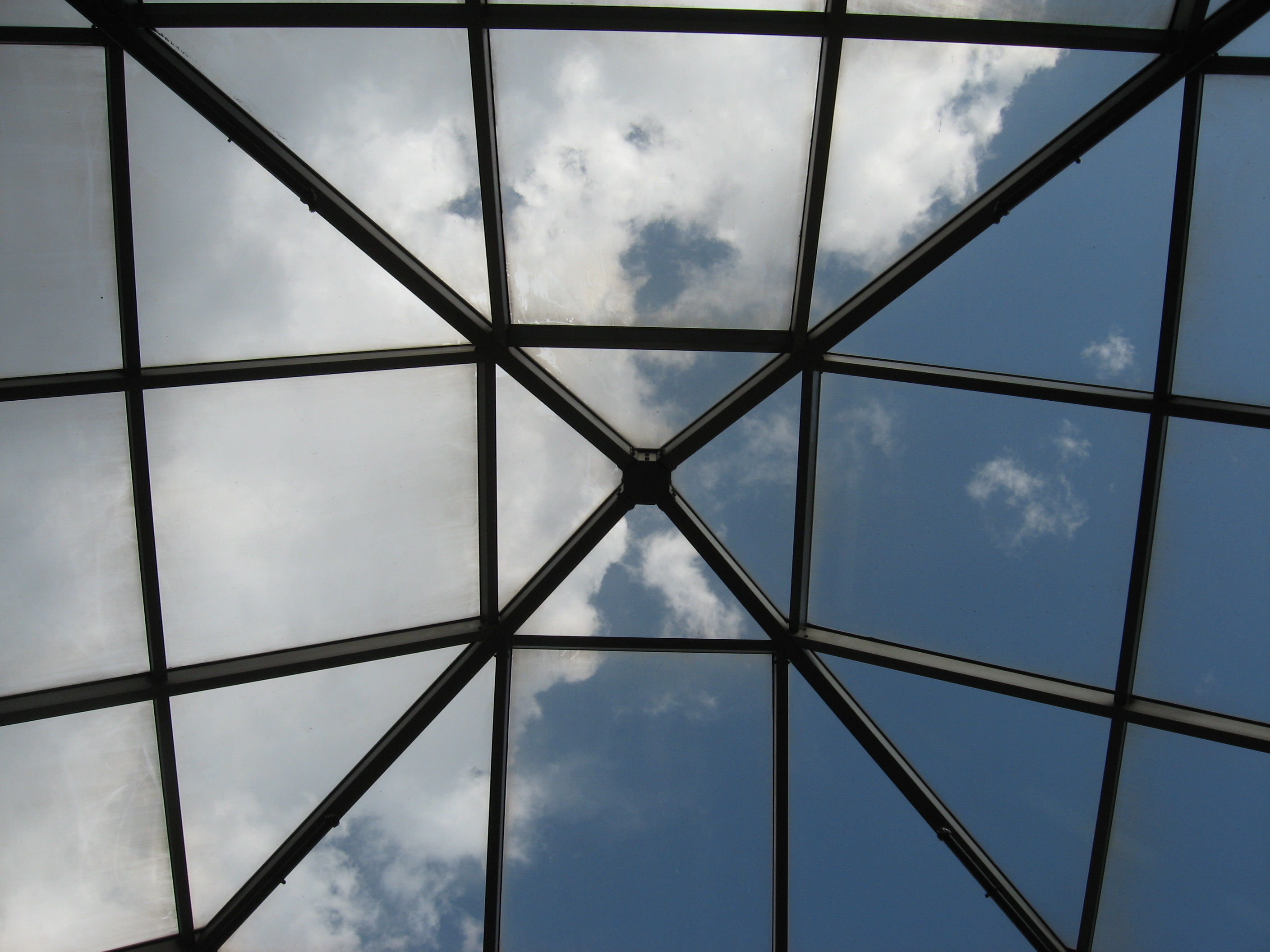 Blue sky and clouds seen through a large skylight
