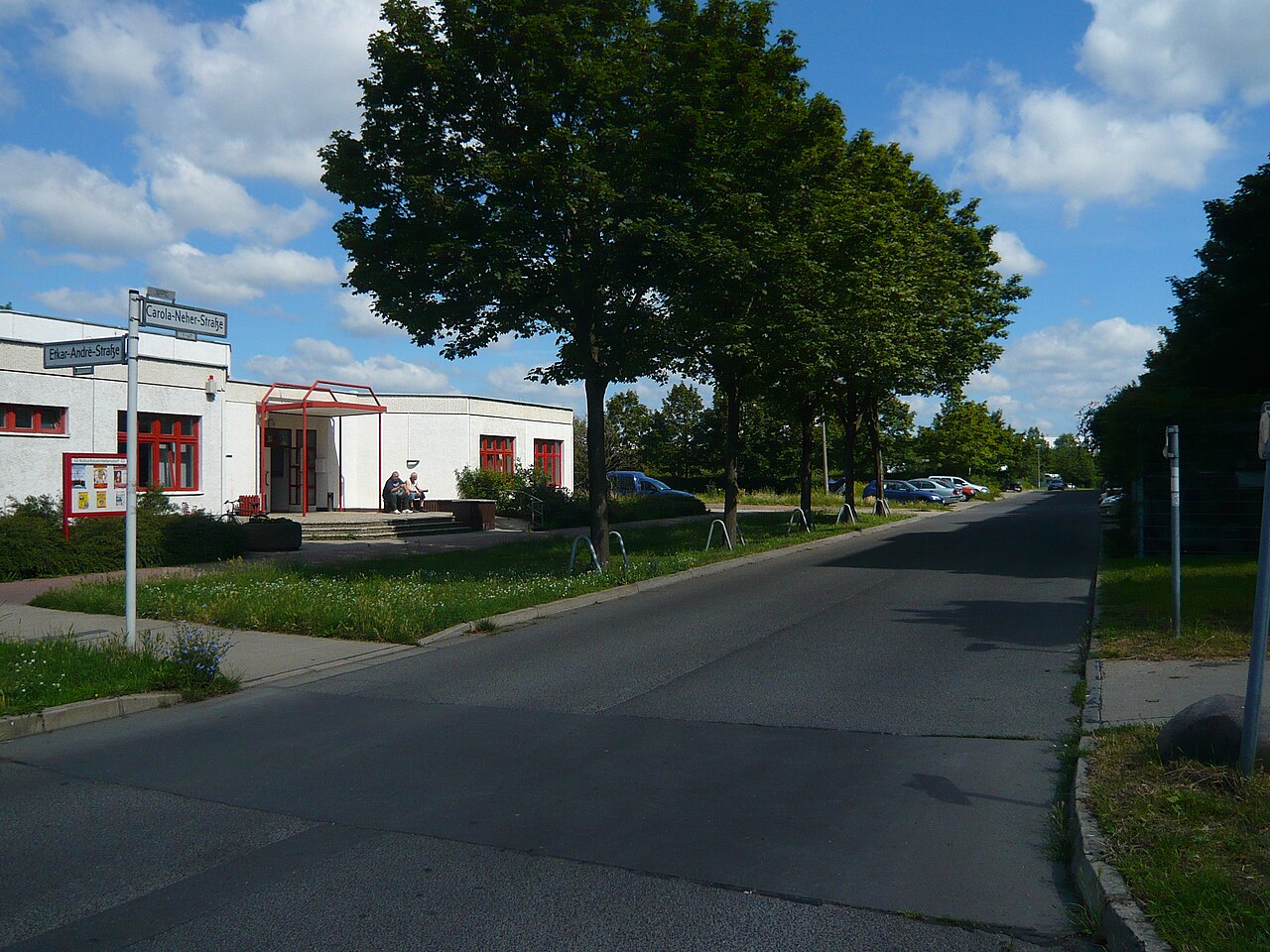 Street view of a low building whose external walls have been re-clad with beige brick slips