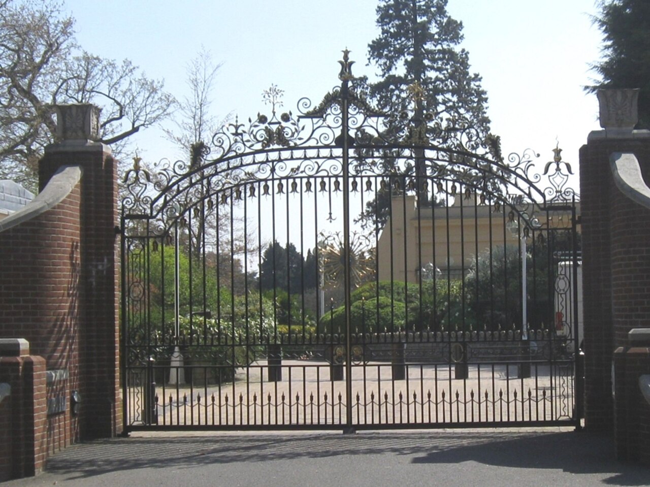 Entrance gates of Tittenhurst Park with security bollards beyond